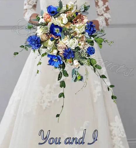 Bouquet with blue and white flowers held by a person wearing a white dress.