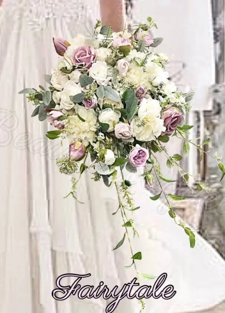 Floral arrangement held by a person with 'Fairytale' branding.