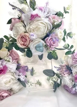 Floral letter 'L' made with roses and other flowers on a white background