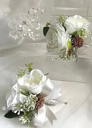 Two white flower corsages on a white background