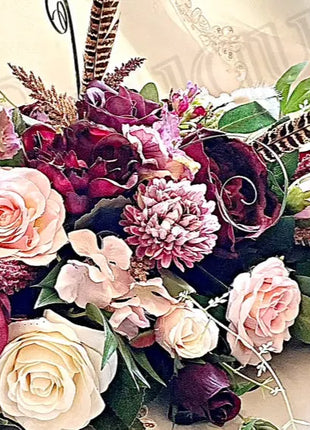 Scottish Table Arrangement with roses pheasant feather In plum Beaux Faux Flowers Shop