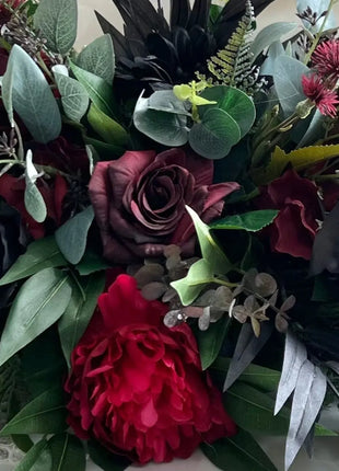 Black red table arrangement of artificial flowers 