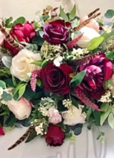 Scottish Table Arrangement with roses pheasant feather In burgundy Beaux Faux Flowers Shop
