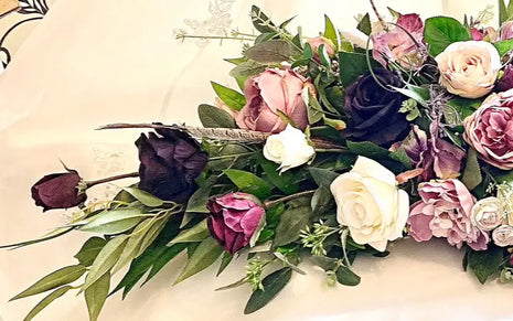Scottish Table Arrangement with roses pheasant feather In plum Beaux Faux Flowers Shop