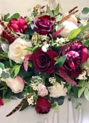 Scottish Table Arrangement with roses pheasant feather In burgundy Beaux Faux Flowers Shop