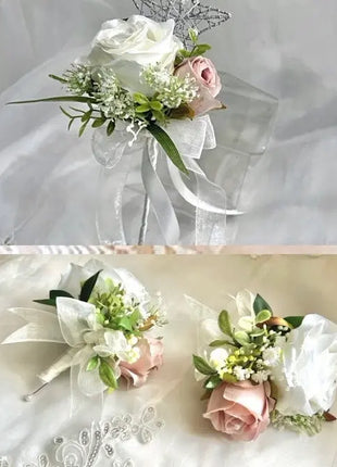 Floral corsage with white roses and greenery on a sheer fabric background.