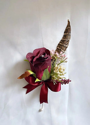 Gents, guest buttonhole with burgundy Red Rose and pheasant feather detail Beaux Faux Flowers Shop