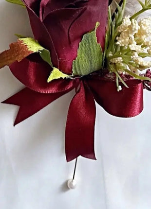 Gents, guest buttonhole with burgundy Red Rose and pheasant feather detail Beaux Faux Flowers Shop