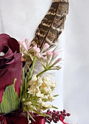 Gents, guest buttonhole with burgundy Red Rose and pheasant feather detail Beaux Faux Flowers Shop