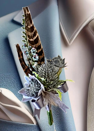 Gents, guest buttonhole with Dusty blue eryngium thistle and pheasant feather detail Beaux Faux Flowers Shop