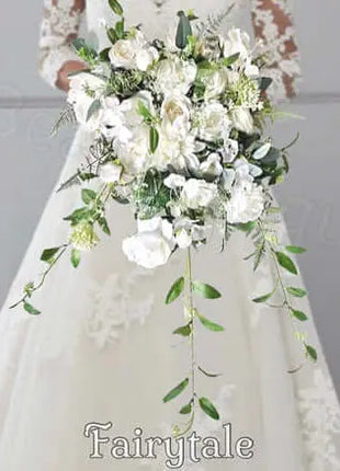 Bouquet of white flowers with green leaves held by a person, with 'Fairytale' branding.