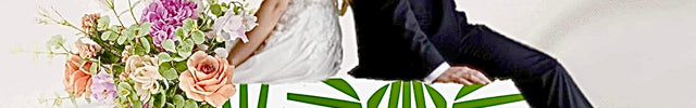 A bride and groom posed on draped white fabric with a large floral sign reading 'Beaux Faux Flowers Shop' in the foreground. The bride wears a white gown and holds a bouquet of pink, peach, and green flowers, while the groom wears a dark navy suit advertising wedding florist- Beaux Faux Flowers Shop 