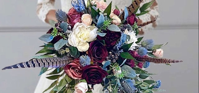 Bouquet of flowers with feathers on a neutral background