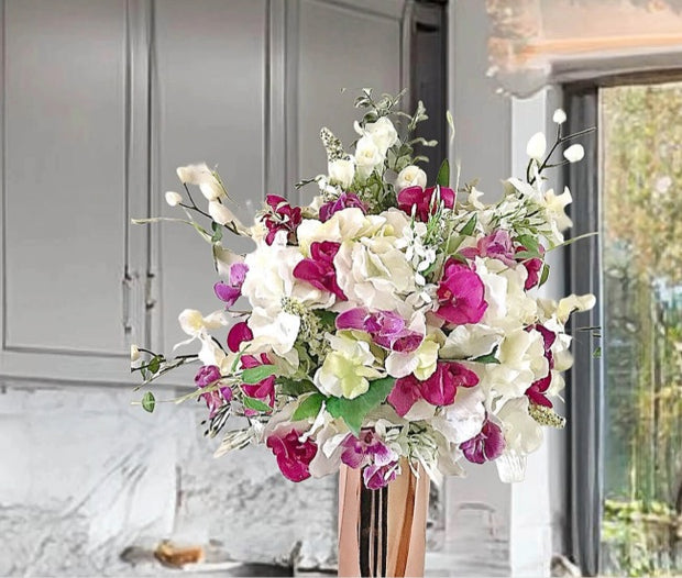 Bouquet of flowers in a vase against a neutral indoor background
